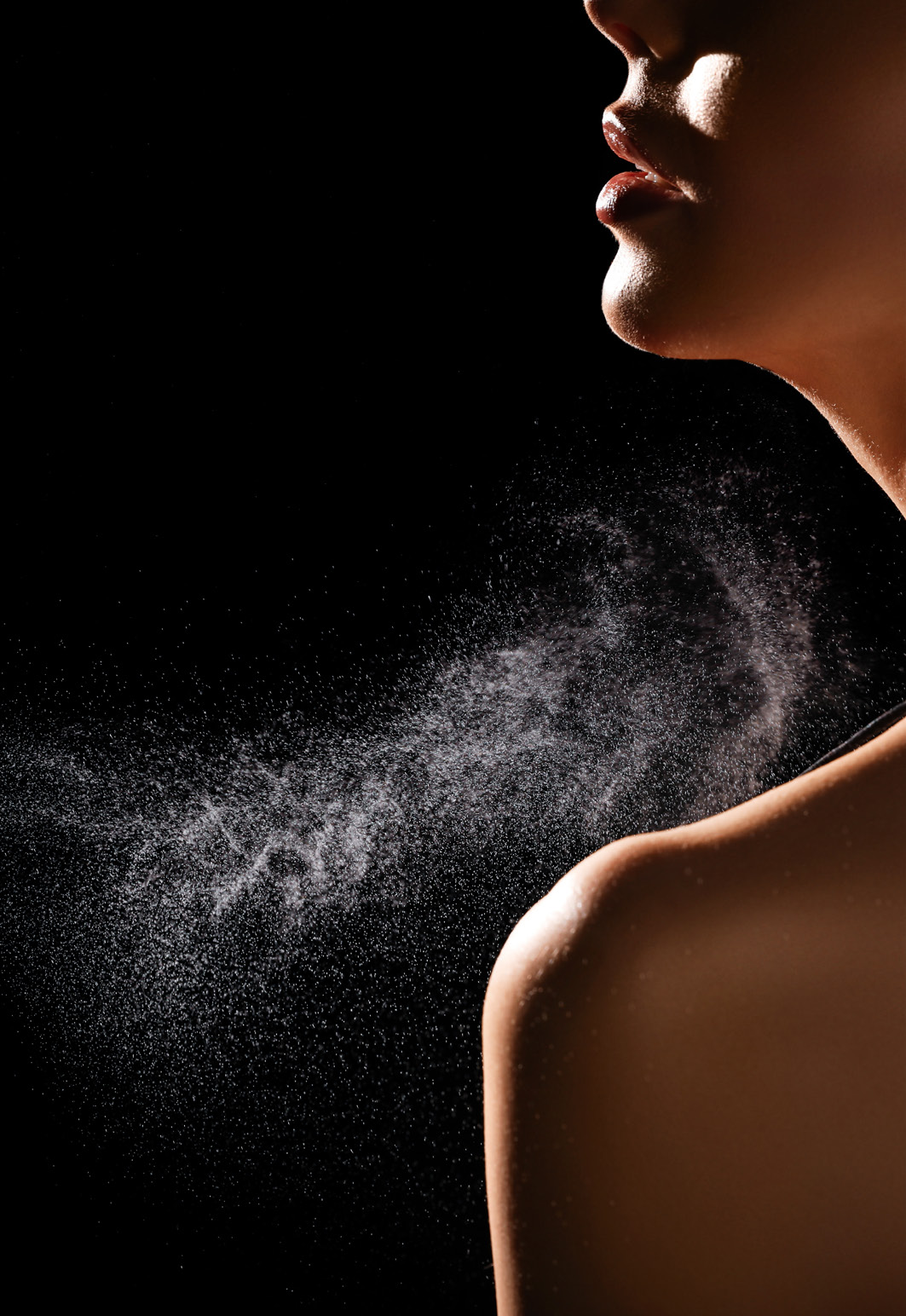 A guest spraying luxury fragrance on their wrist